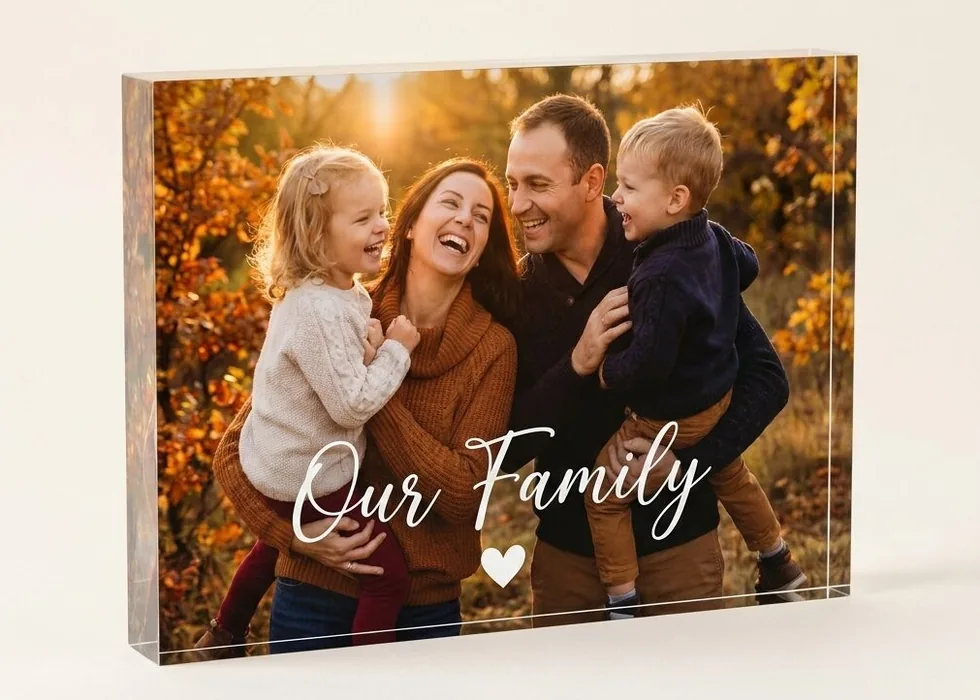 The same 5-by-7-inch acrylic photo block turned landscape, printed with a family photograph captioned Our Family.
